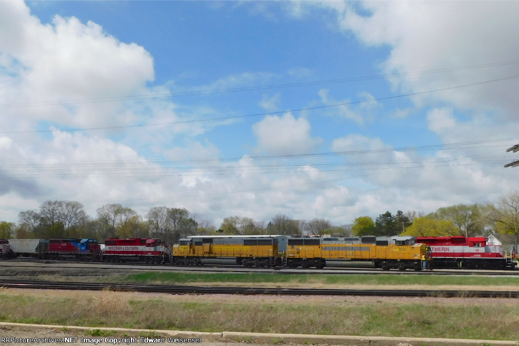 T4 quartet backs a lone CITX covered hopper to the CPKC interchange track